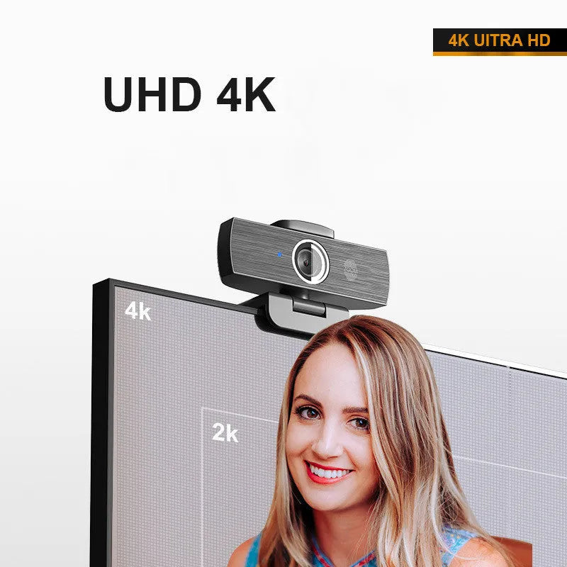 Black computer camera with magnetic privacy cover attached, showing USB cable connection