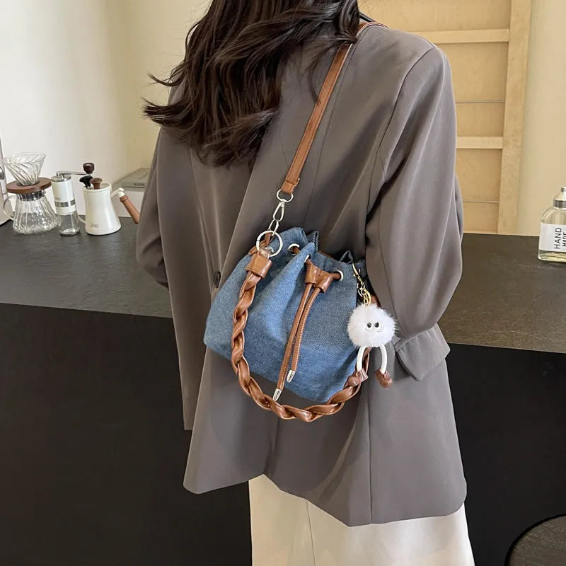 Blue one-shoulder cross body bucket bag with synthetic leather lining and sandwich pocket design