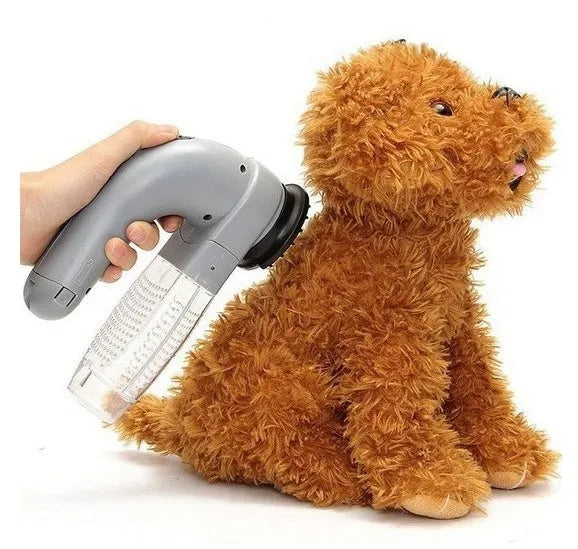 Grey portable electric pet hair vacuum cleaner with soft rubber grooming head.