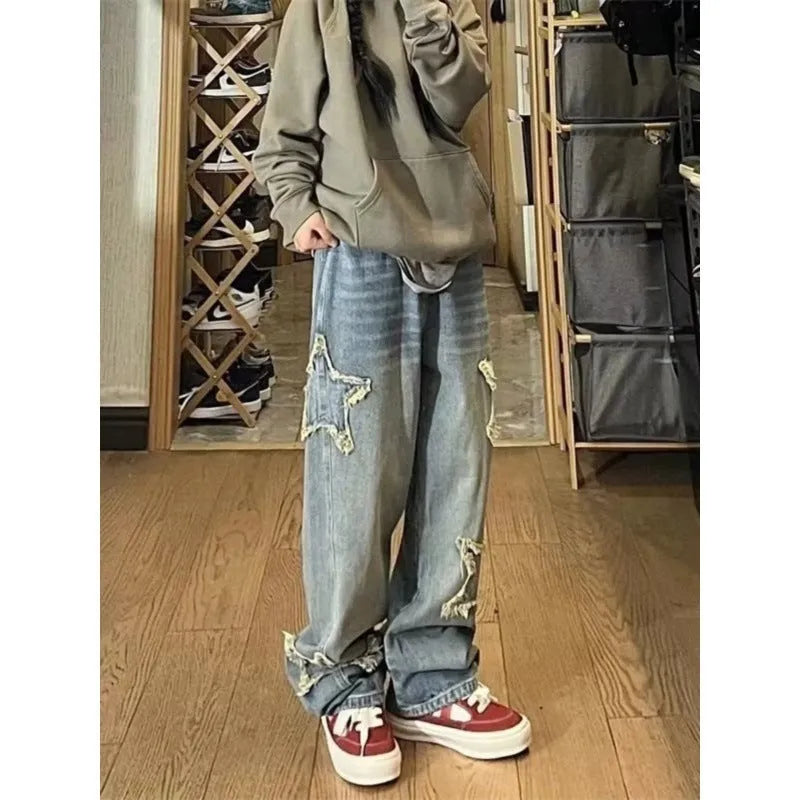 Blue high-waisted wide-leg denim pants with straight-leg silhouette on hanger