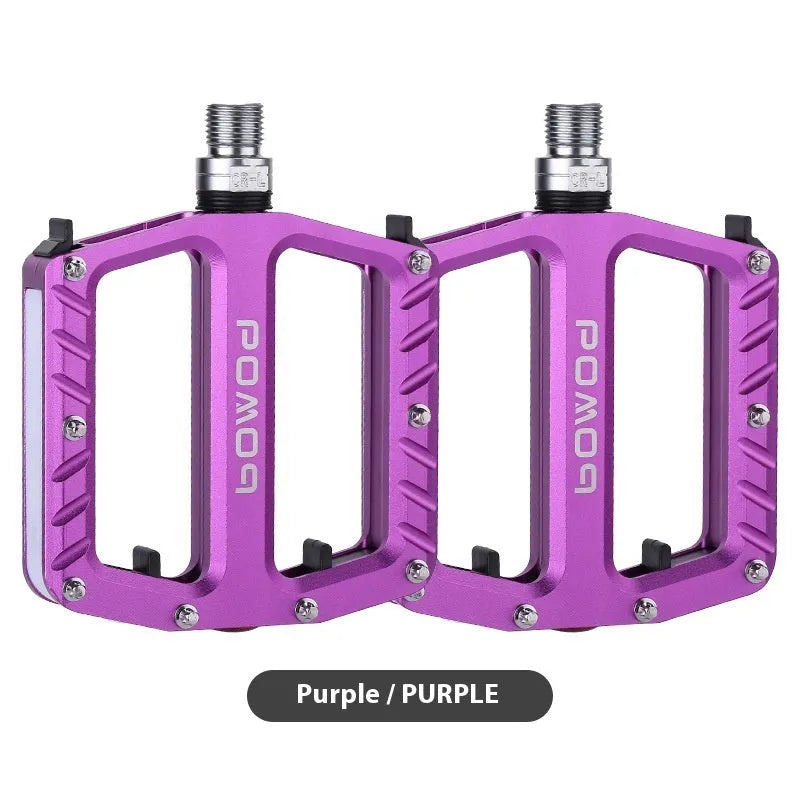 Pair of aluminium alloy bicycle pedals with integrated LED lights in multiple colour options.