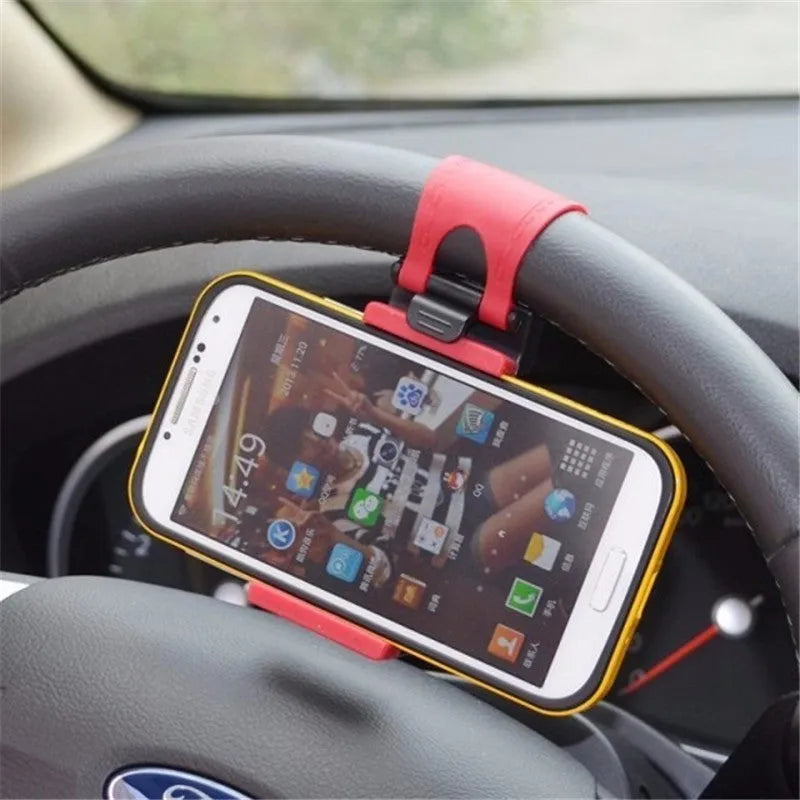 Black steering wheel phone holder clip mounted on car steering wheel holding smartphone