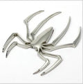 Three-dimensional metal spider bumper sticker in zinc alloy, showing gold colour option.