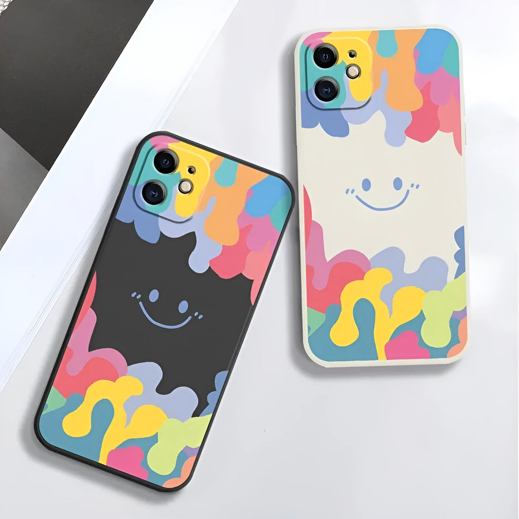 White silicone phone case with a rainbow smiley face design and a black lanyard attached.