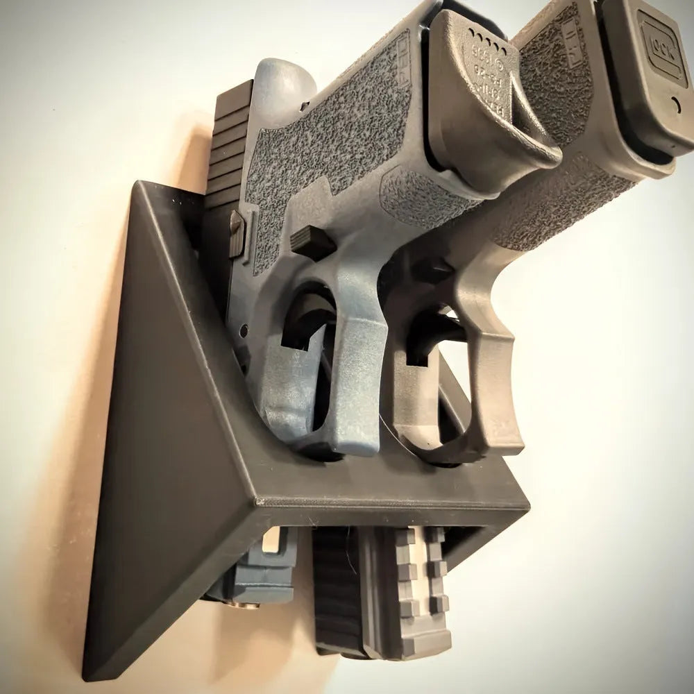 Black plastic punk-style pistol stand for model gun display measuring 10.85cm by 7.6cm