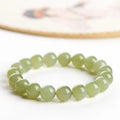 Polished Hetian jade ball bracelet in ice-like clear water colours on a wrist.