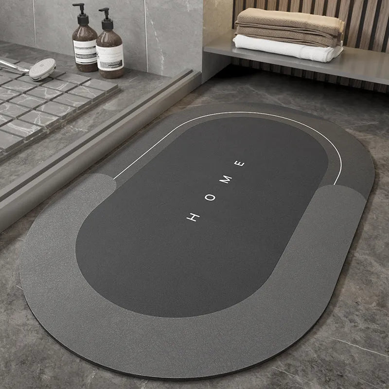 Blue oval blended bathroom floor mat on tiled floor next to a bath.