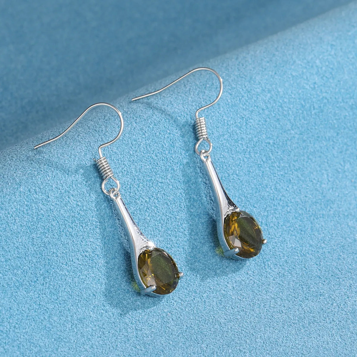 Olive green topaz drop earrings with minimalist water drop shape on alloy backing