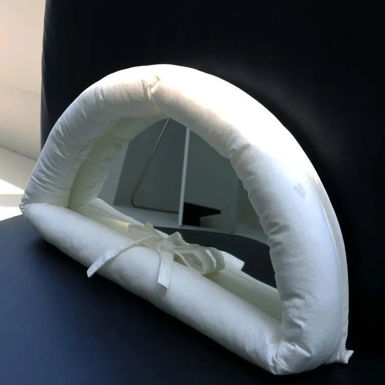 Hanging soft cotton-filled fabric mirror in solid colour on wall