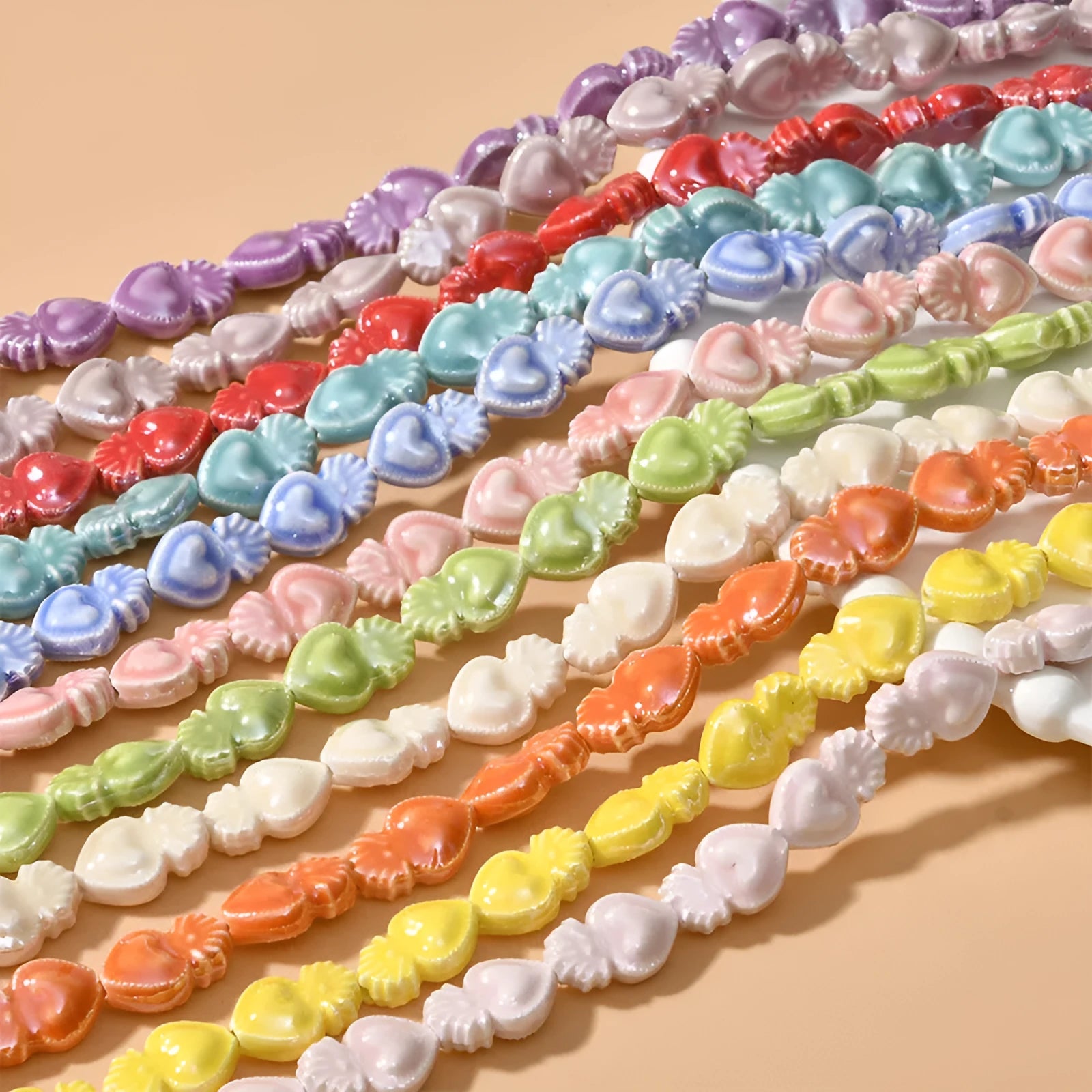 Ceramic love heart torch beads in multiple colours showing 10x15mm size and straight hole design
