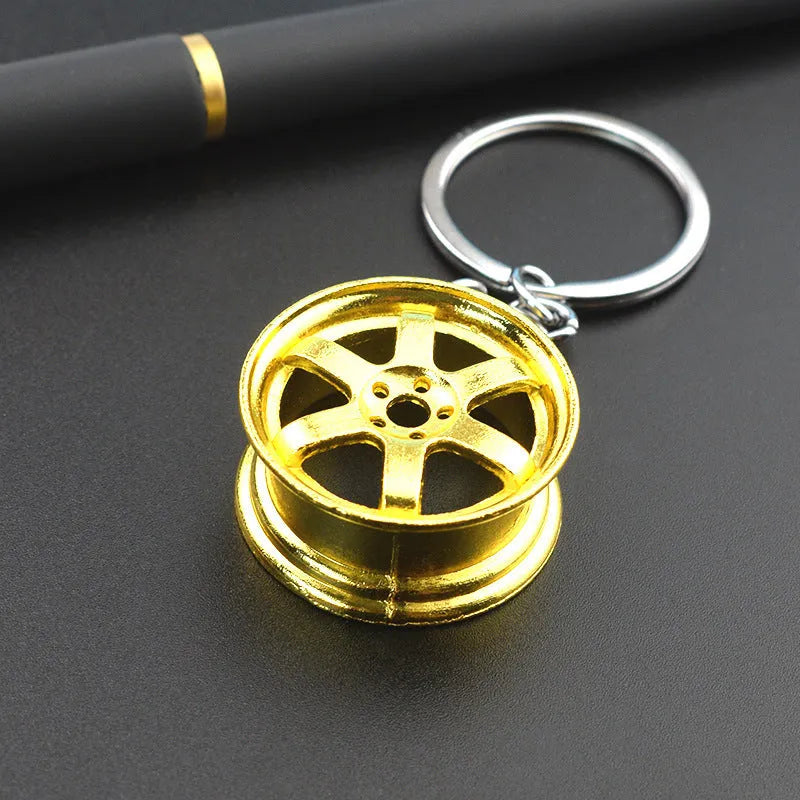 Creative car modification wheel hub metal keychain in gold finish on a keyring