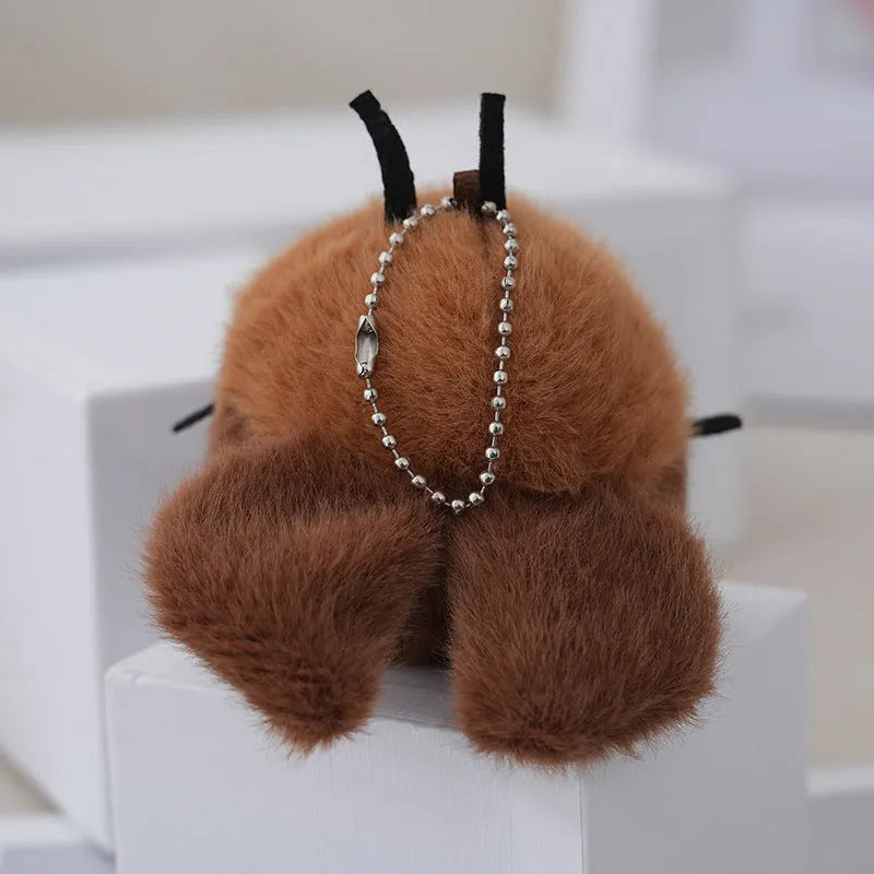 Small mink velvet cockroach pendant plush toy doll with black eyes, 8cm height, on a light background