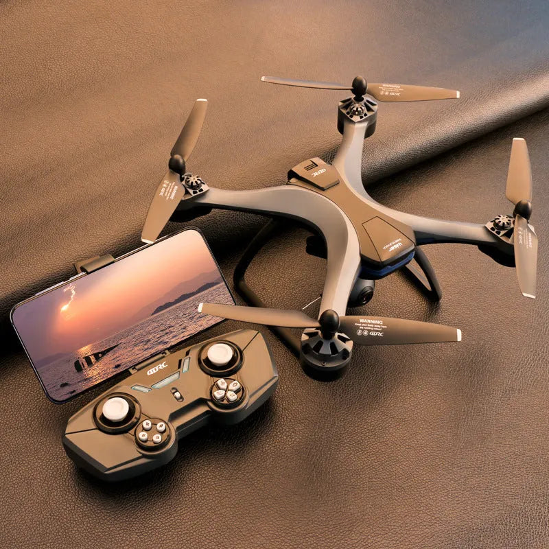 Plastic quadrocopter drone with GPS, remote controller, spare blades, and landing gear on grey background