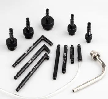 13-piece automatic transmission oil refuelling kit with injector tool and connector attachments on a bench.