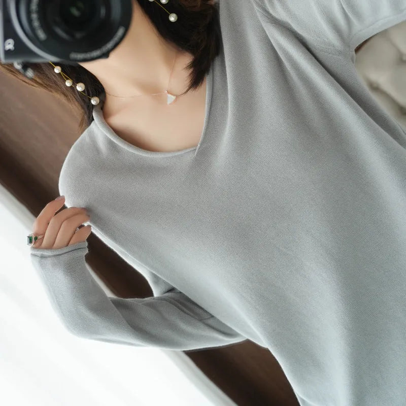 Women's grey V-neck long sleeve knitwear pullover on a hanger