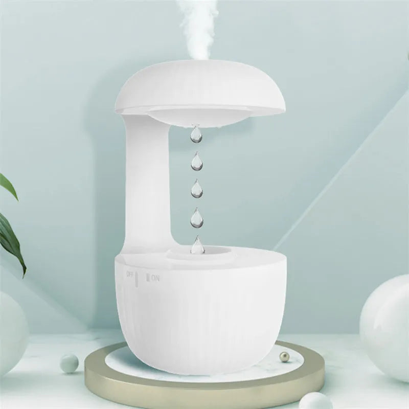 White anti-gravity air humidifier with levitating water drops and USB cable on a desk