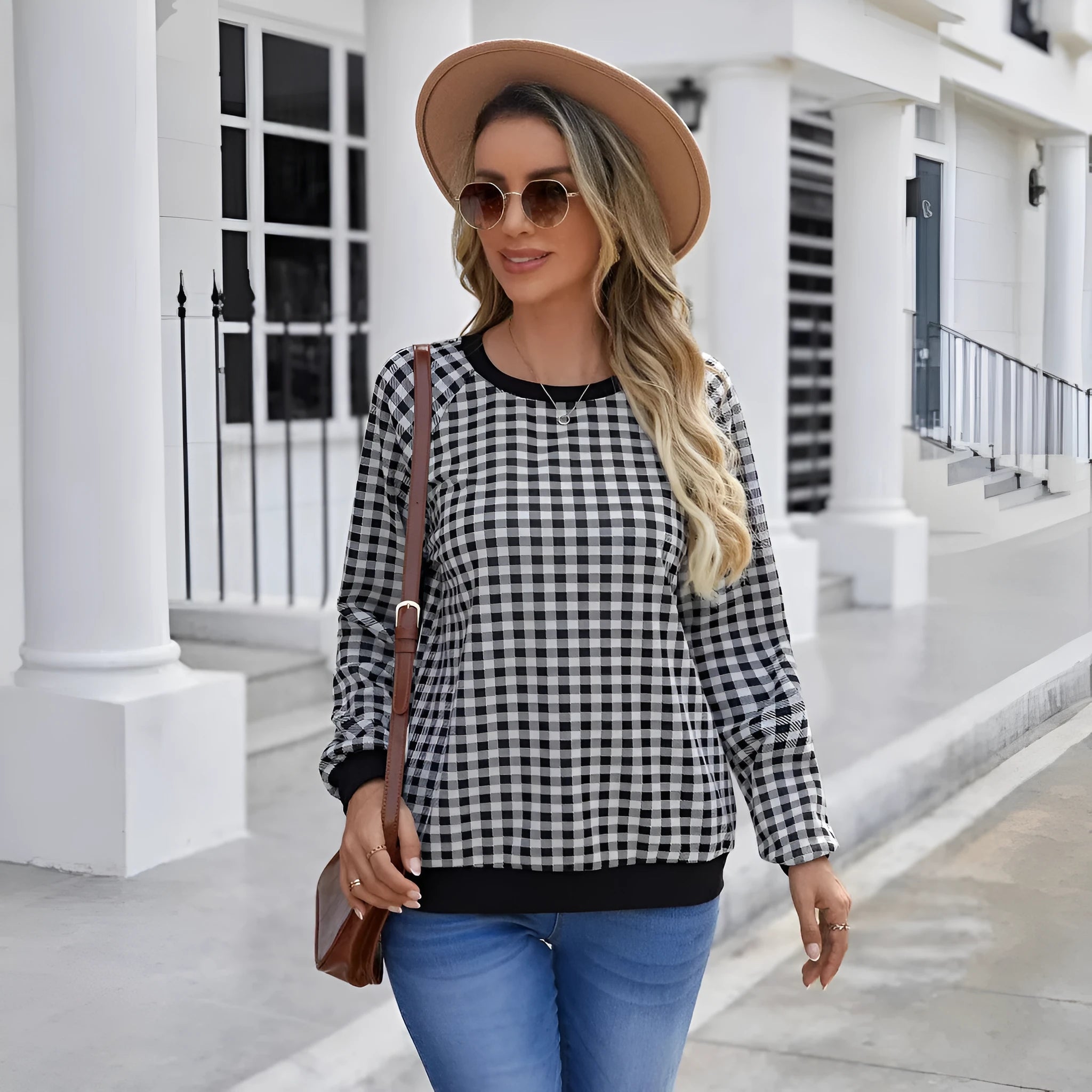 Black long sleeve pullover sweater with plaid stripes and printed pattern on a mannequin.