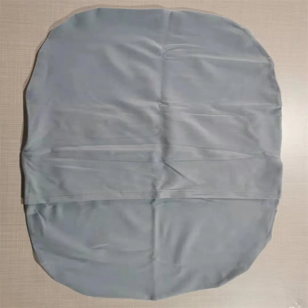 Beige portable baby nest crib cot for newborns on a neutral background.