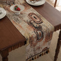 Dark blue Nordic jacquard table flag with striped bouquet pattern and tassel fringe on a wooden table.