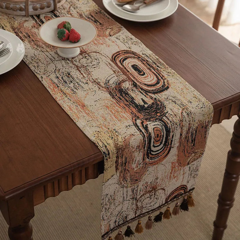 Dark blue Nordic jacquard table flag with striped bouquet pattern and tassel fringe on a wooden table.