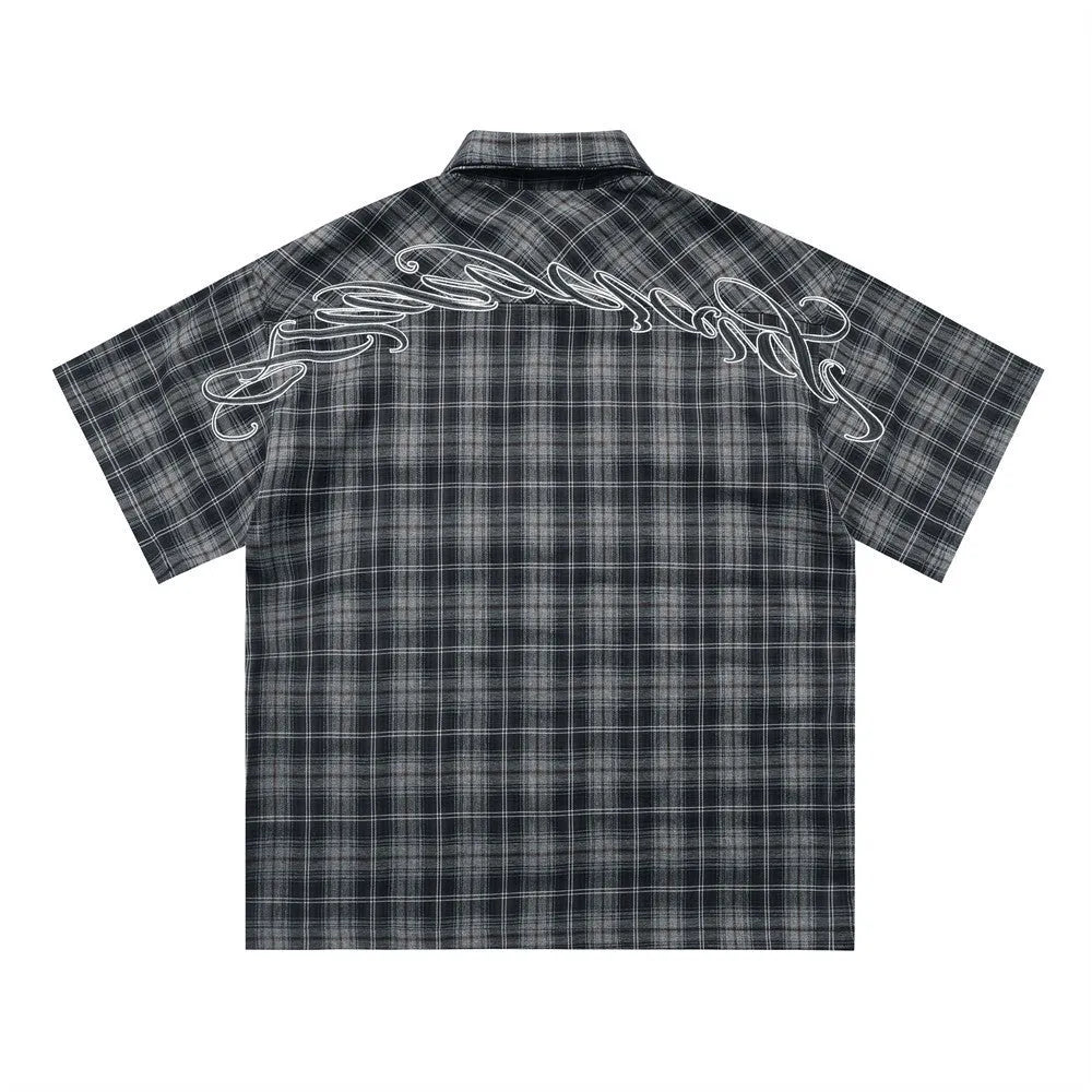 Men's black and brown plaid short sleeve shirt with embroidered lettering and lapel collar