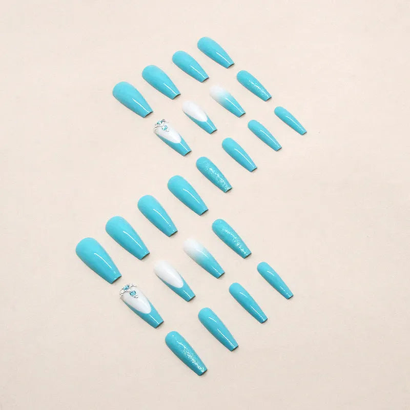 Long smart blue diamond false ballet nails with glitter particles and glue tube.