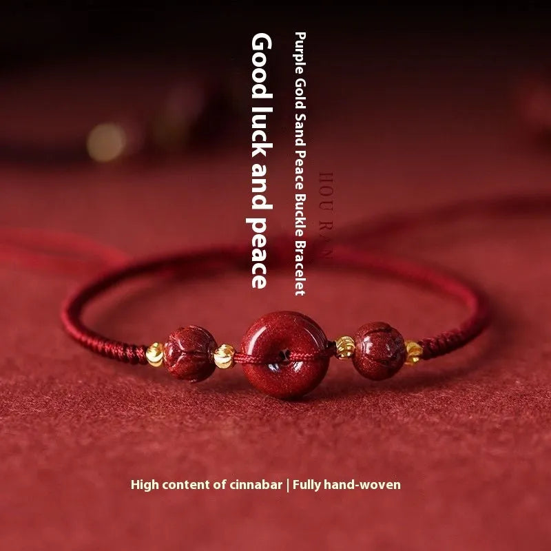 Heart-shaped cinnabar pendant on adjustable safety buckle bracelet with red cord