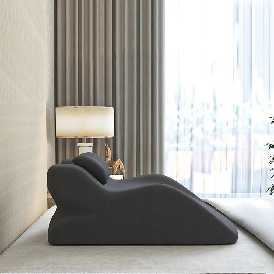 A blue stomach sleeper pillow on a bed, designed for lying face down.