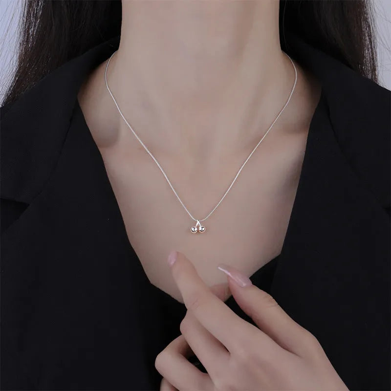 Silver cherry necklace for women with adjustable snake bone chain and fruit-shaped pendant.