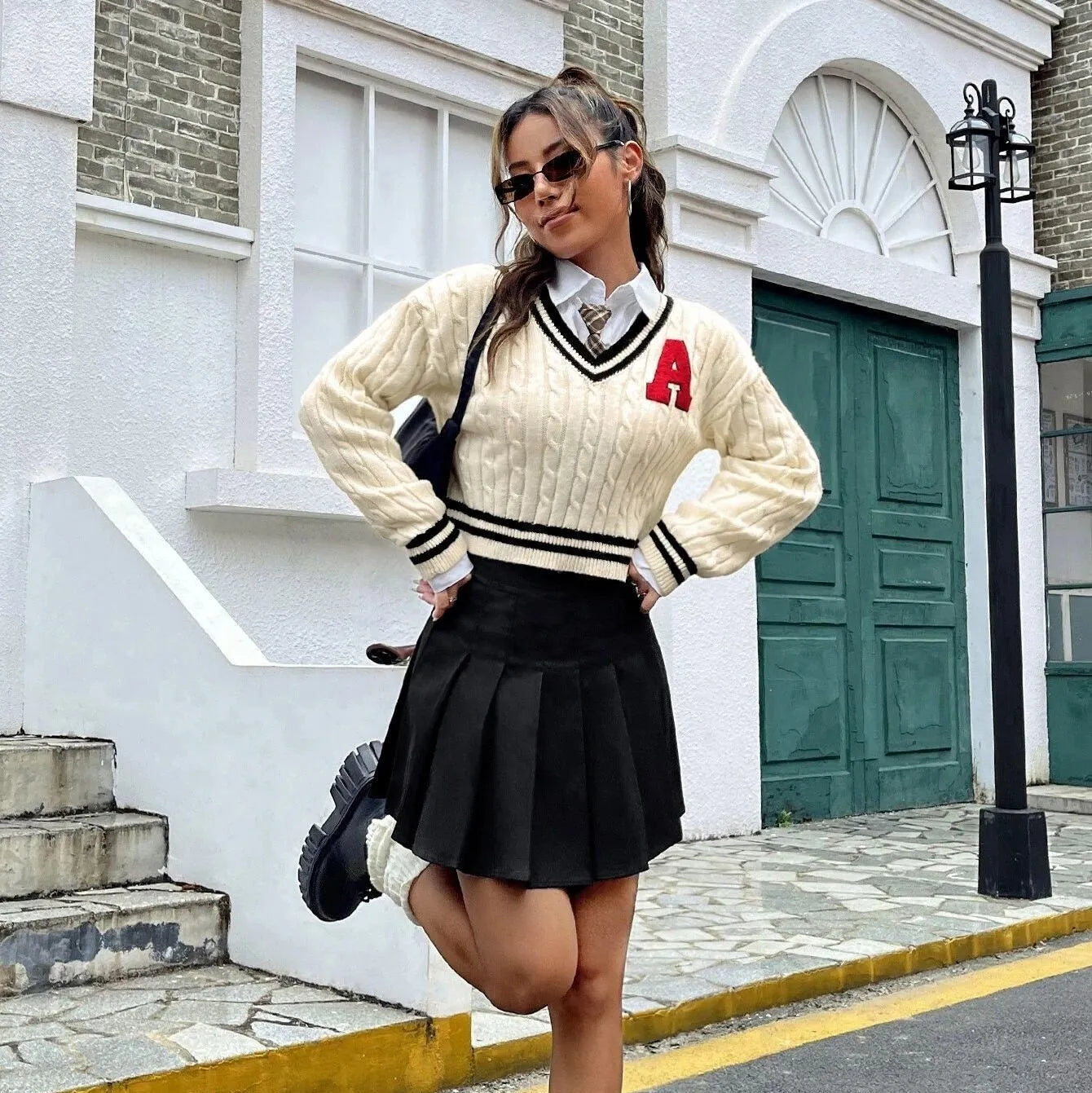 V-neck creamy white knitted shirt with slim stripes and patch detail on model