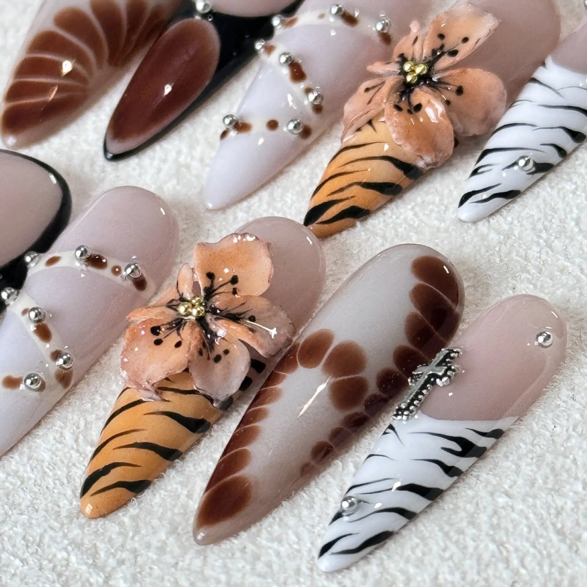 Ten artificial nail stickers with leopard print, cross, and floral patterns in French style design