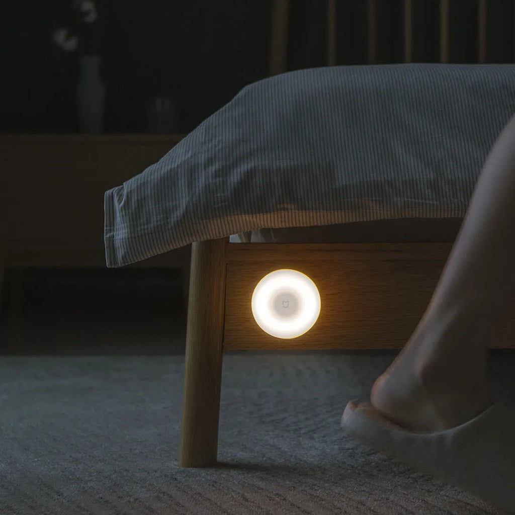 White modern Mijia induction bedside lamp with compact cubic design on a table.