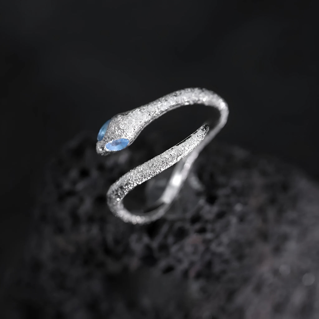 Silver adjustable snake ring with platinum colour finish on a white background