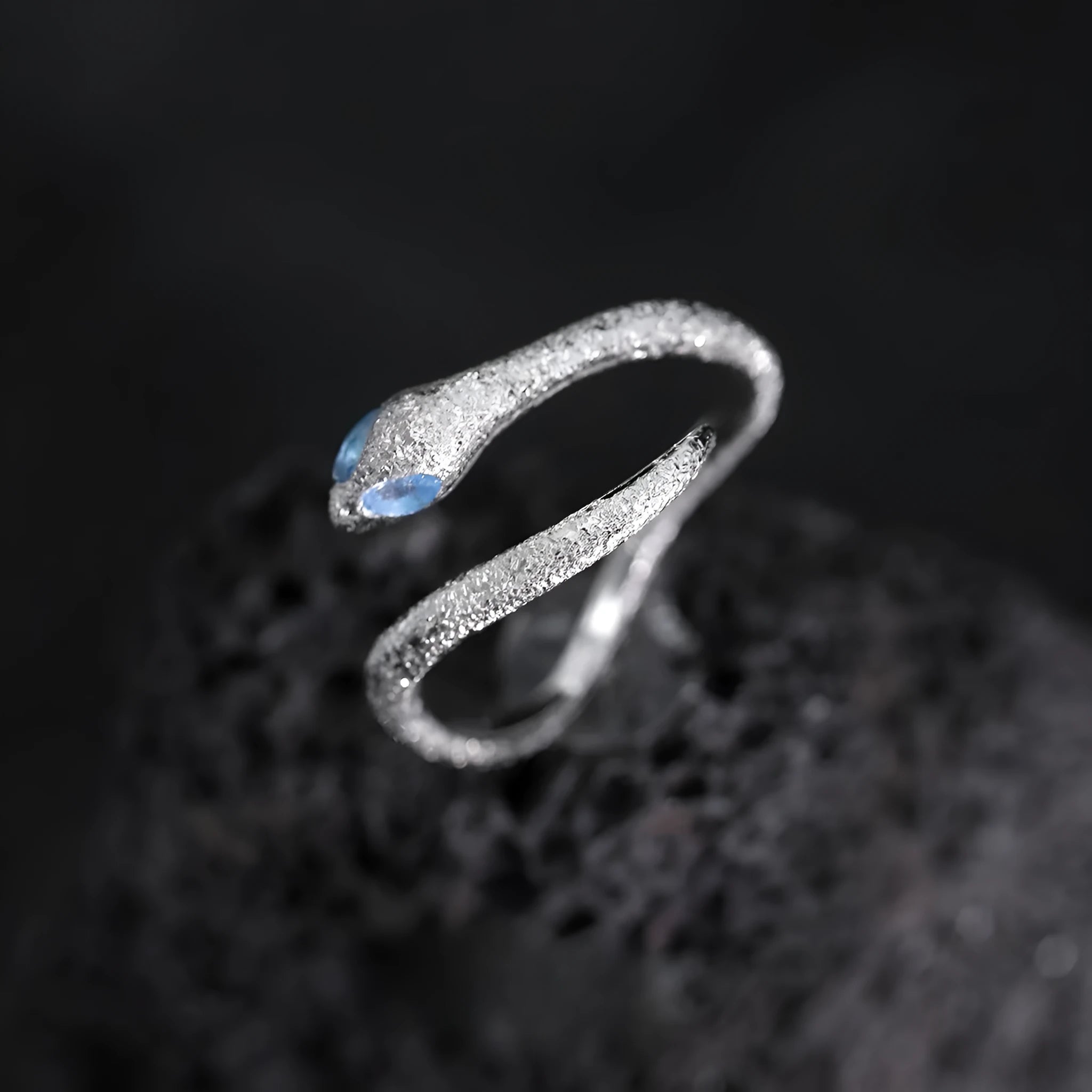Silver adjustable snake ring with platinum colour finish on a white background
