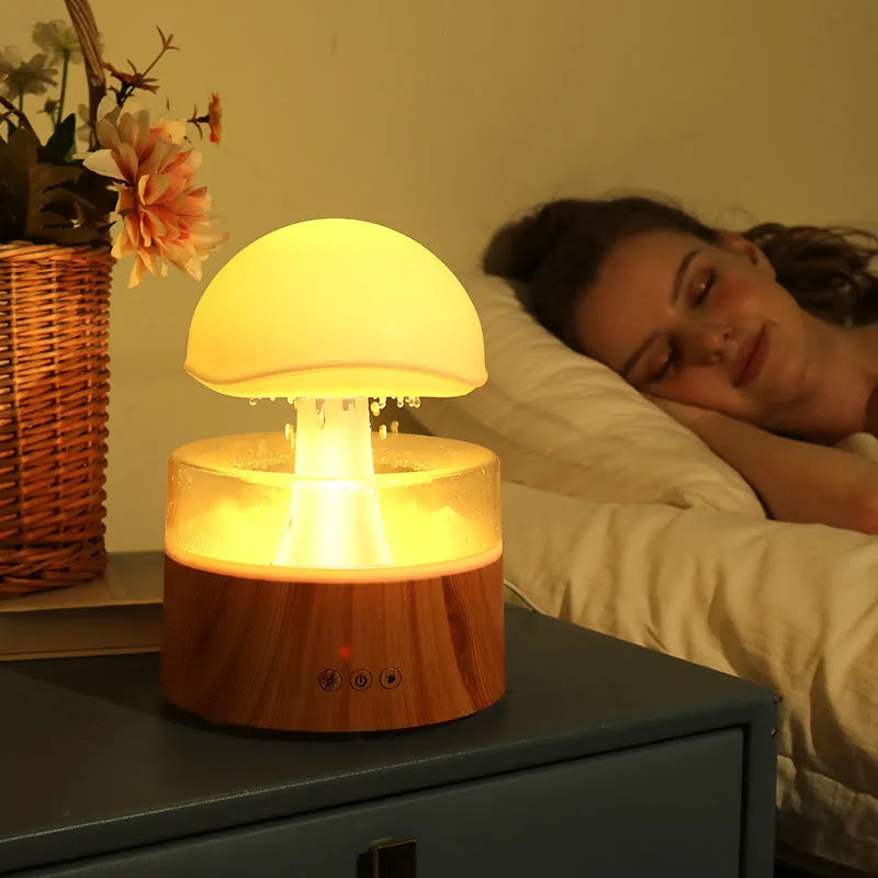 White cloud-shaped aromatherapy humidifier with LED lights and simulated raindrops.