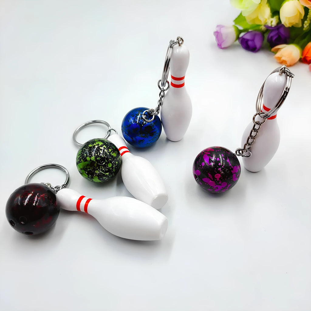 Mini bowling ball keychain pendant in PVC metal available in four colours: dark red, blue, purple, green