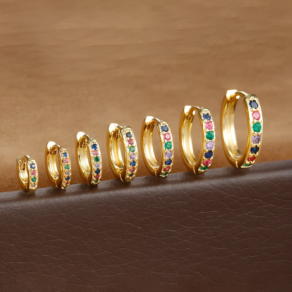 Circle-shaped zircon stud earrings in gold, rose gold, or silver colour on a white background.