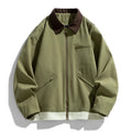 Man wearing a mint green loose-fit retro jacket with dark contrast lapels and side seam pockets.