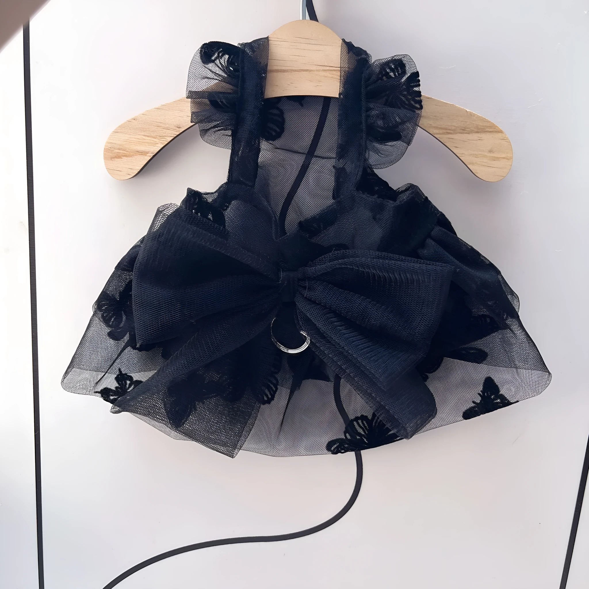 Black tulle princess skirt pet costume on small dog with size chart showing five available sizes