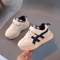 Children's solid-colour Velcro sneaker in beige with a rubber sole and synthetic leather upper.