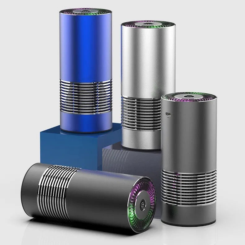 Compact aluminium alloy car air purifier in black, silver, or metallic grey for dashboard use.