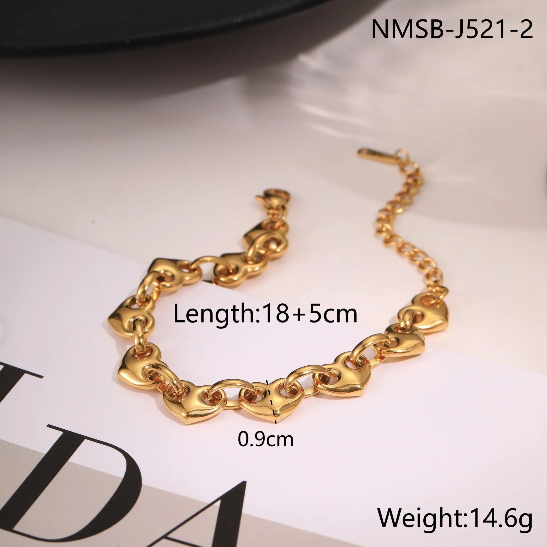 Women's stainless steel bracelet featuring a hollowed-out geometric heart design in gold or steel finish.