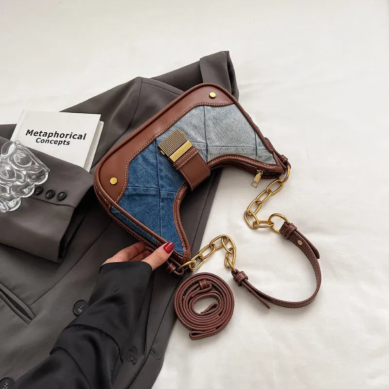 Brown denim bucket shoulder bag with diamond mesh panels and metallic chain strap