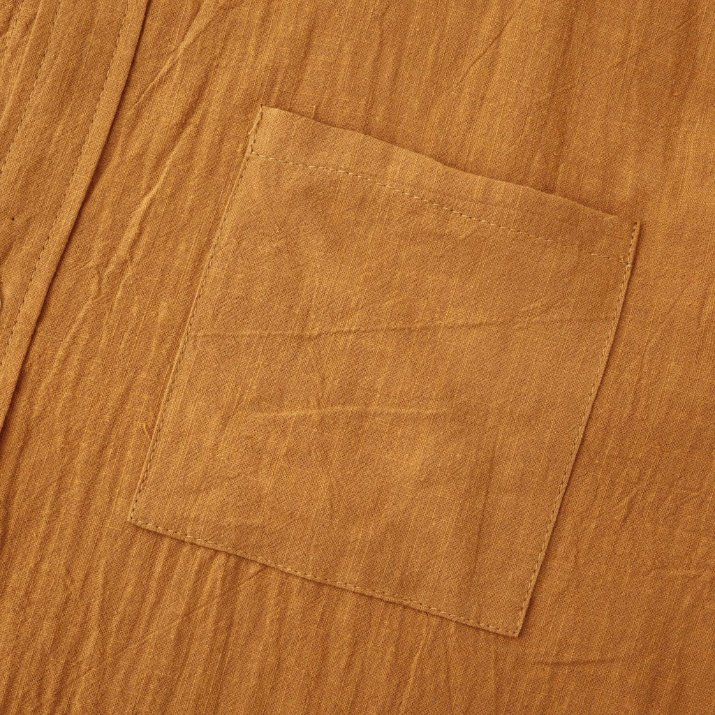 Men's slim fit brown cotton blend long sleeve shirt and matching casual trousers laid flat.