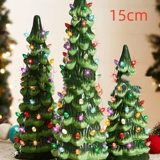 A resin Christmas tree-shaped lamp ornament with LED lights, shown in different sizes on a table.
