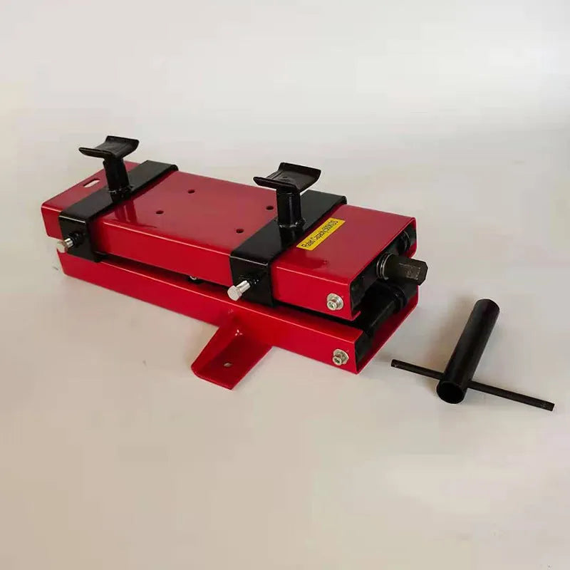 Red motorcycle support lift table raising a bike 16 inches above the ground for repair work