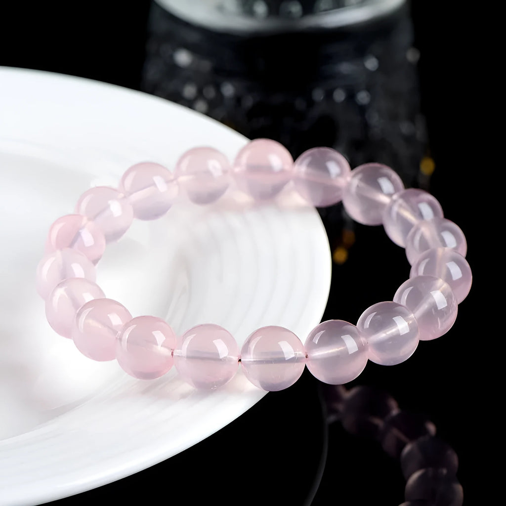 Natural starlight crystal round bead bracelet in pink with polished beads in multiple size options