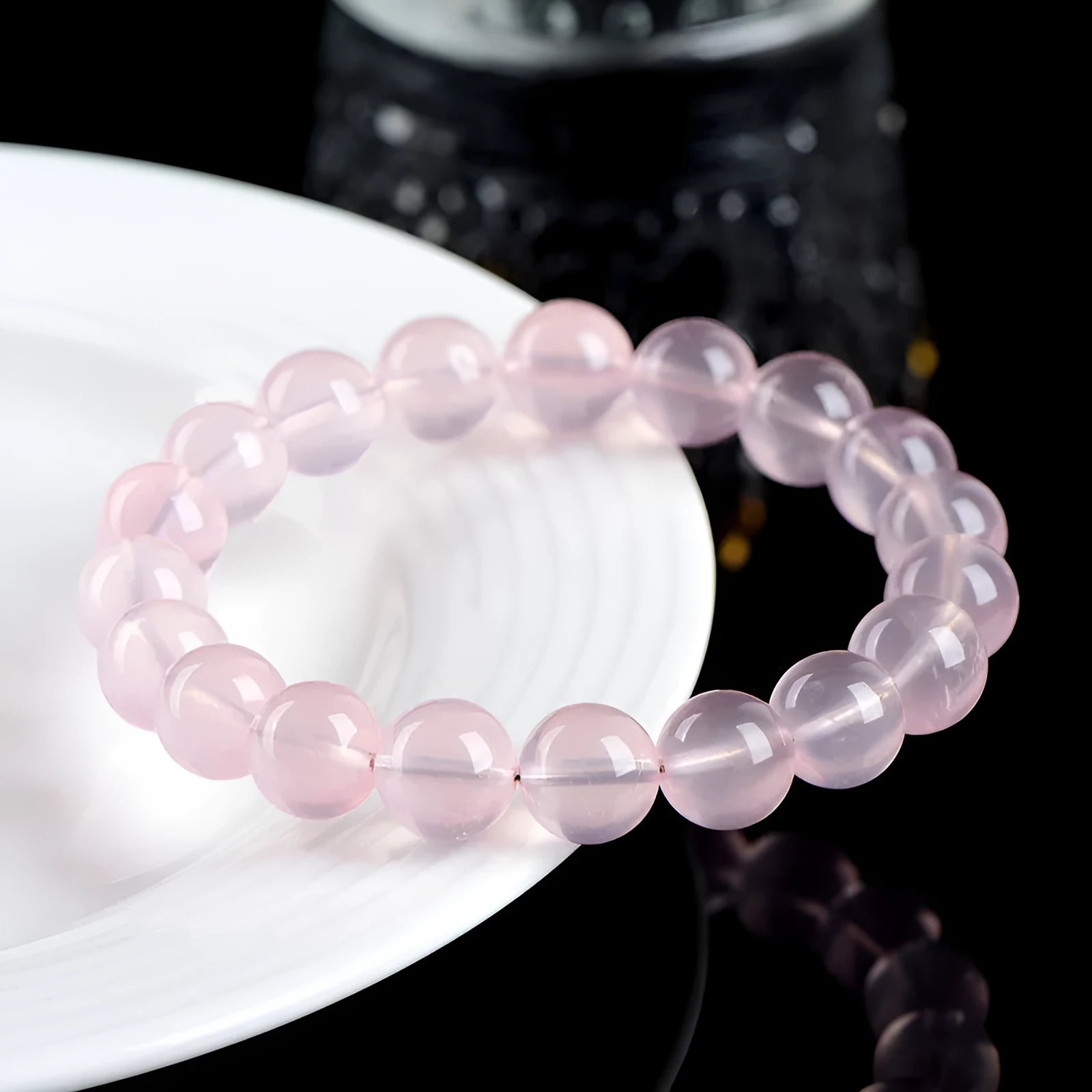 Natural starlight crystal round bead bracelet in pink with polished beads in multiple size options