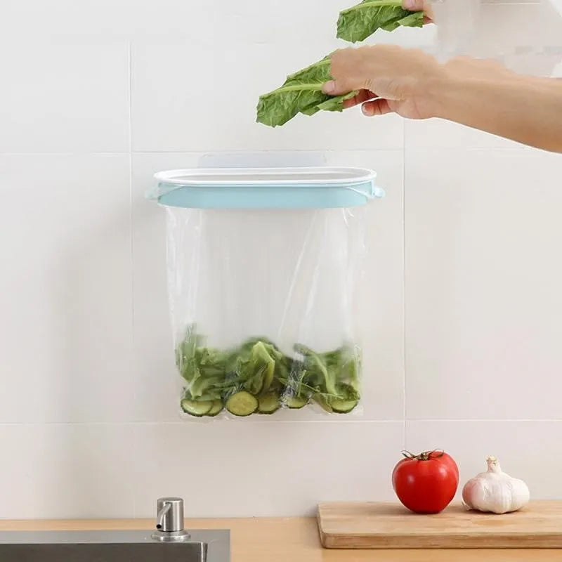 Blue plastic kitchen garbage bag storage rack on a worktop holding a roll of bin liners.