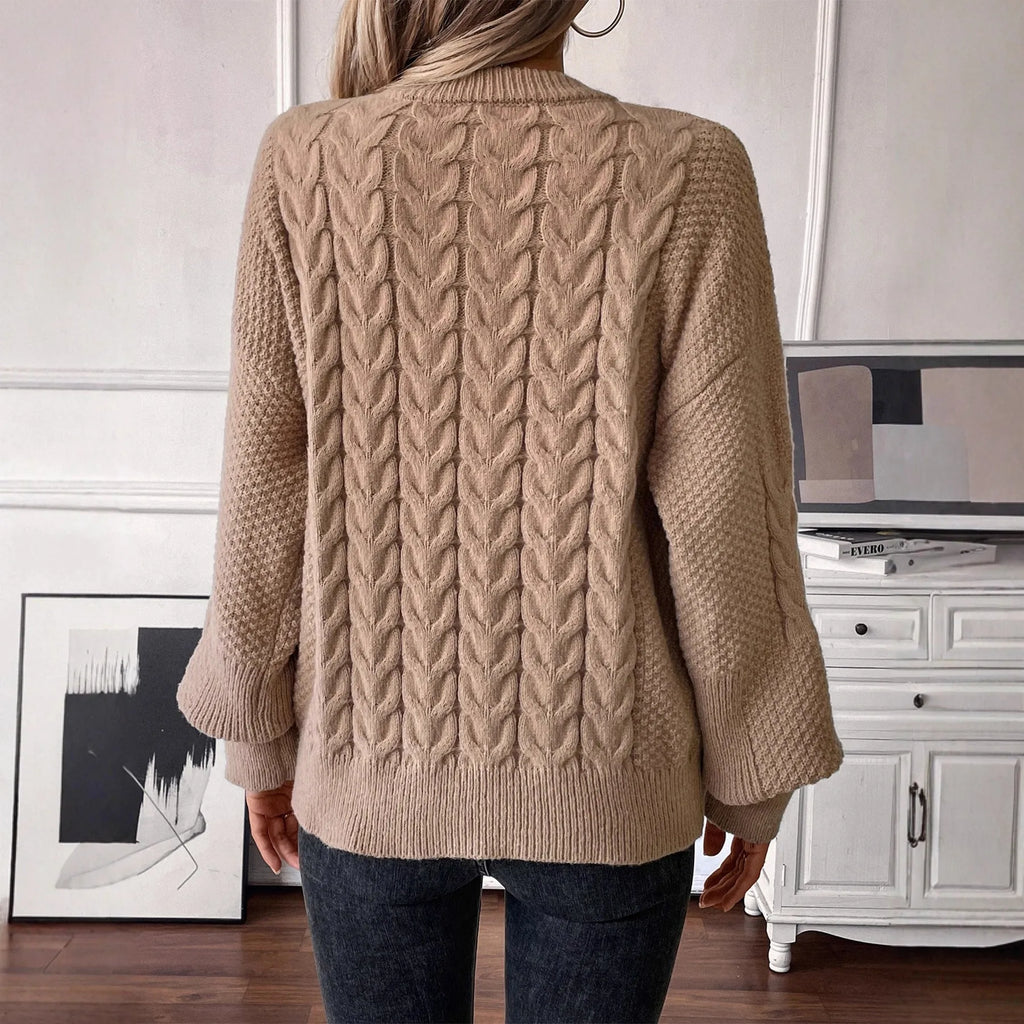 Women's loose beige round neck pullover sweater on a hanger.